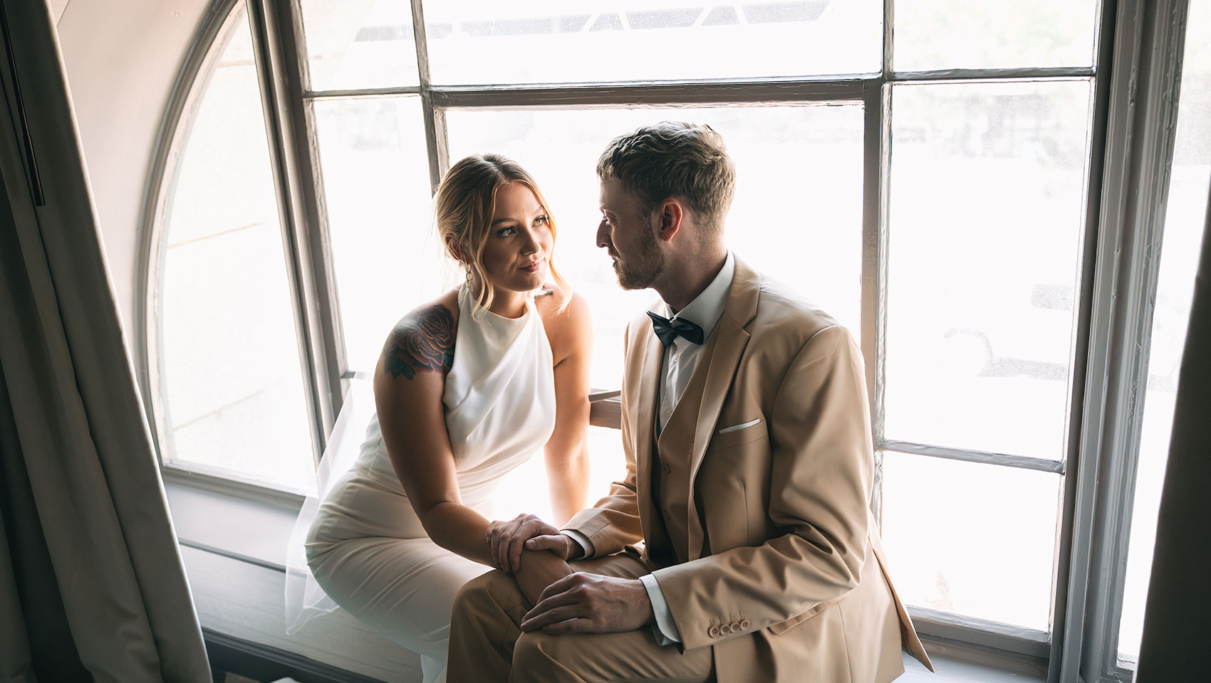 Bride and Groom in front of window