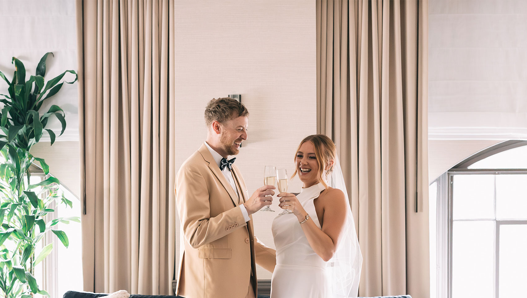 Bride and groom in front of couch