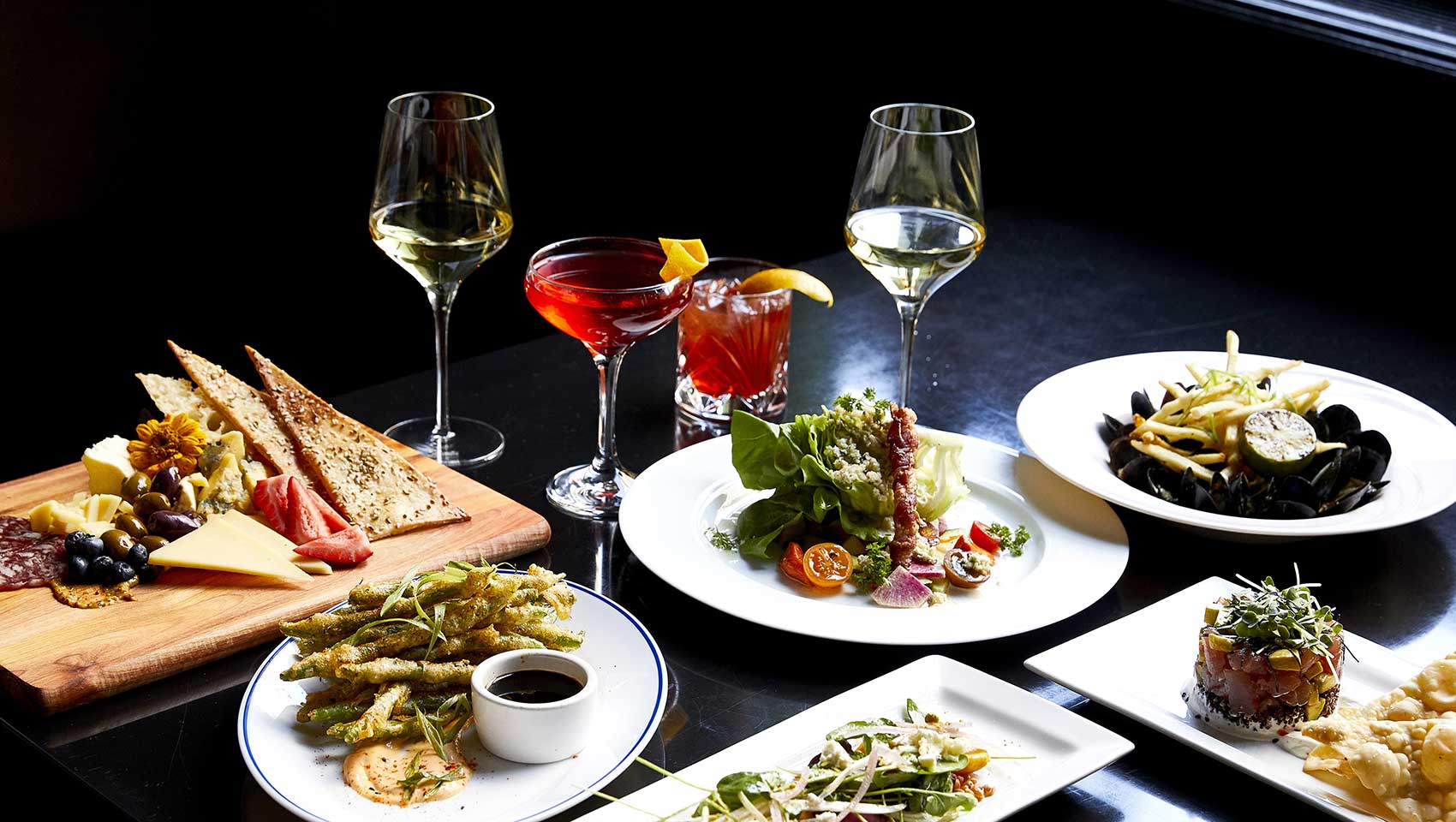 a variety of dishes and wine at Bambara