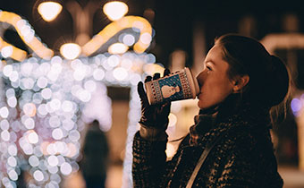 woman sipping on a cup of coffee