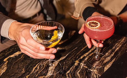 Hands holding cocktails